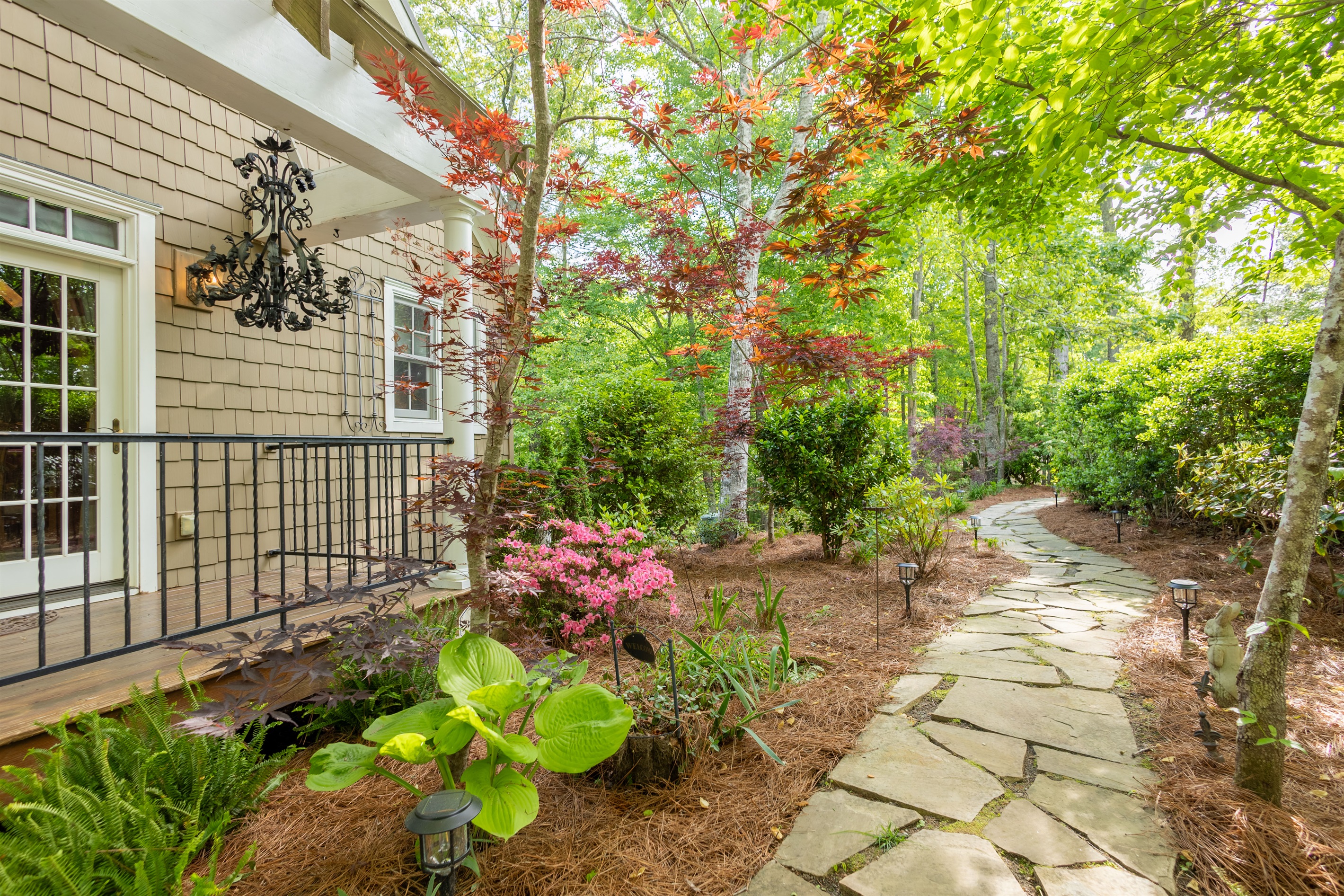 Enjoy the beautifully maintained outdoor spaces and peaceful garden pathways that surround the home.