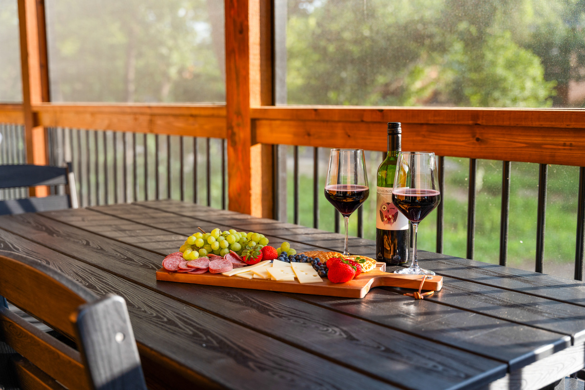 Al fresco charcuterie on the screened porch, bug-free and shaded by oaks.