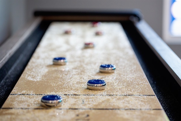 Challenge friends to a fun game on our sleek shuffleboard table!