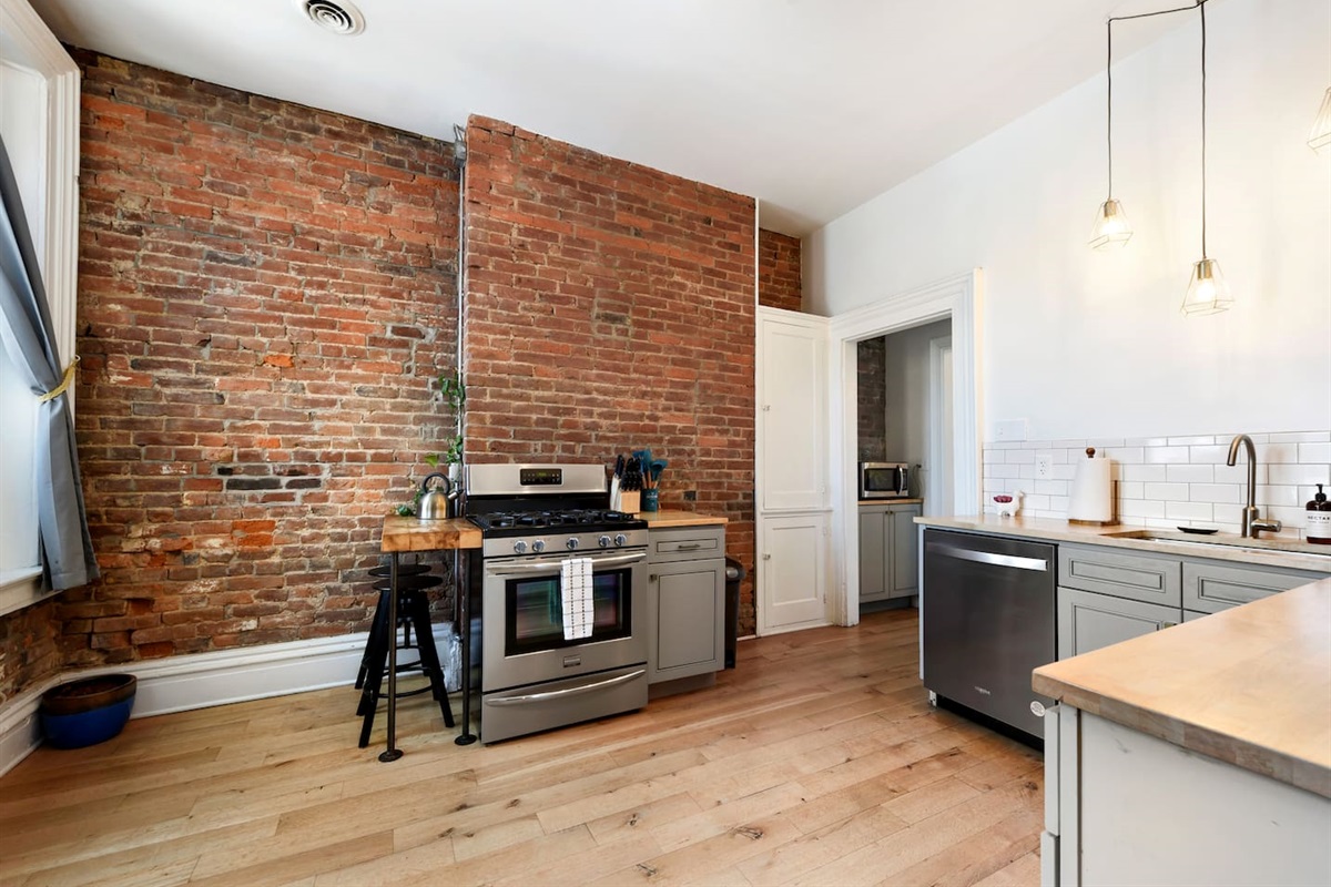 Fully equipped kitchen featuring modern design and sleek stainless steel appliances — ready for all your cooking needs.
