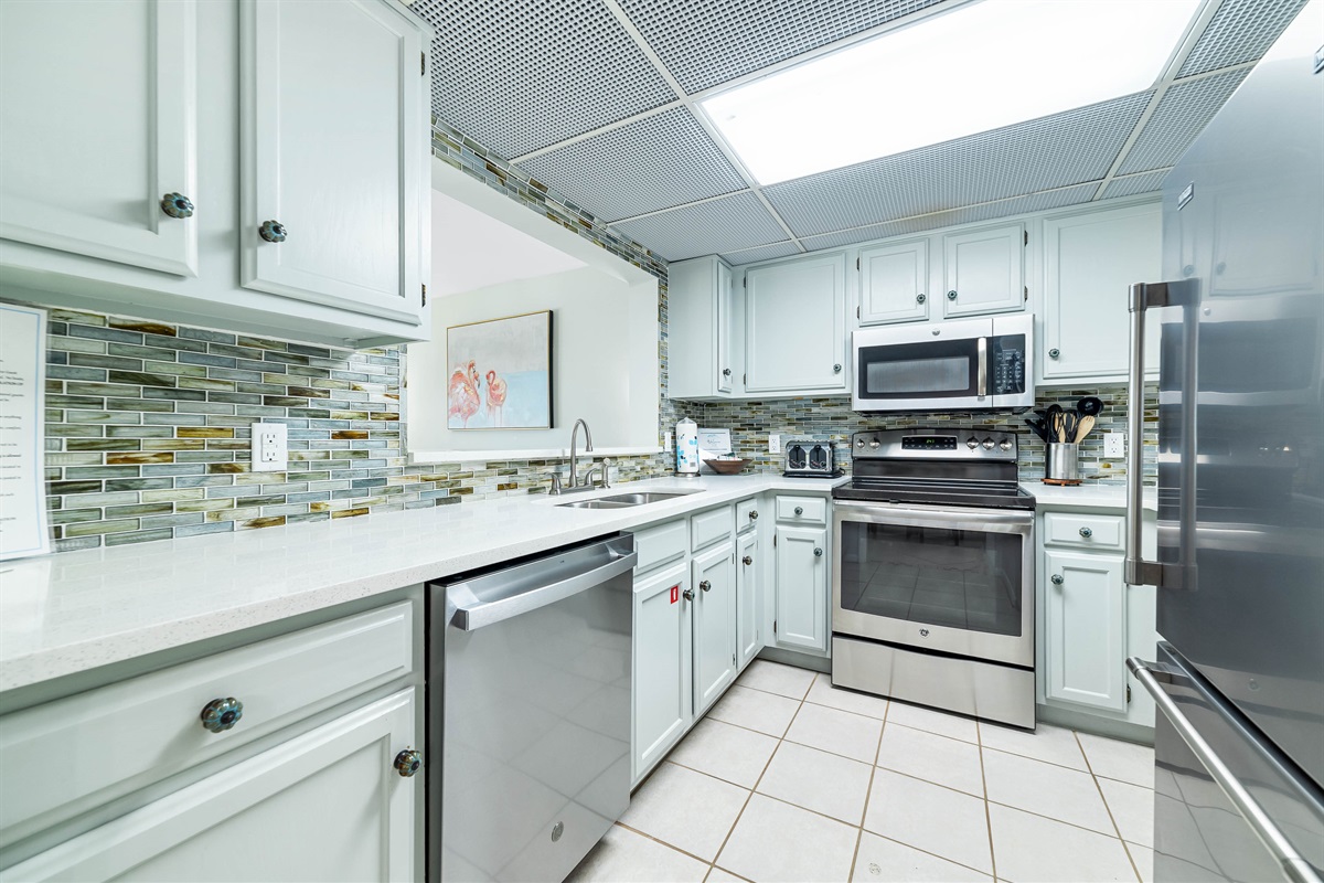A well-equipped kitchen featuring modern appliances and stylish finishes, perfect for culinary enthusiasts.