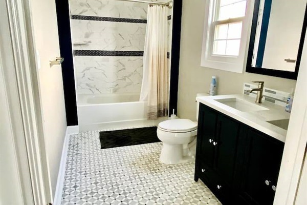 Large full bathroom with double sink.