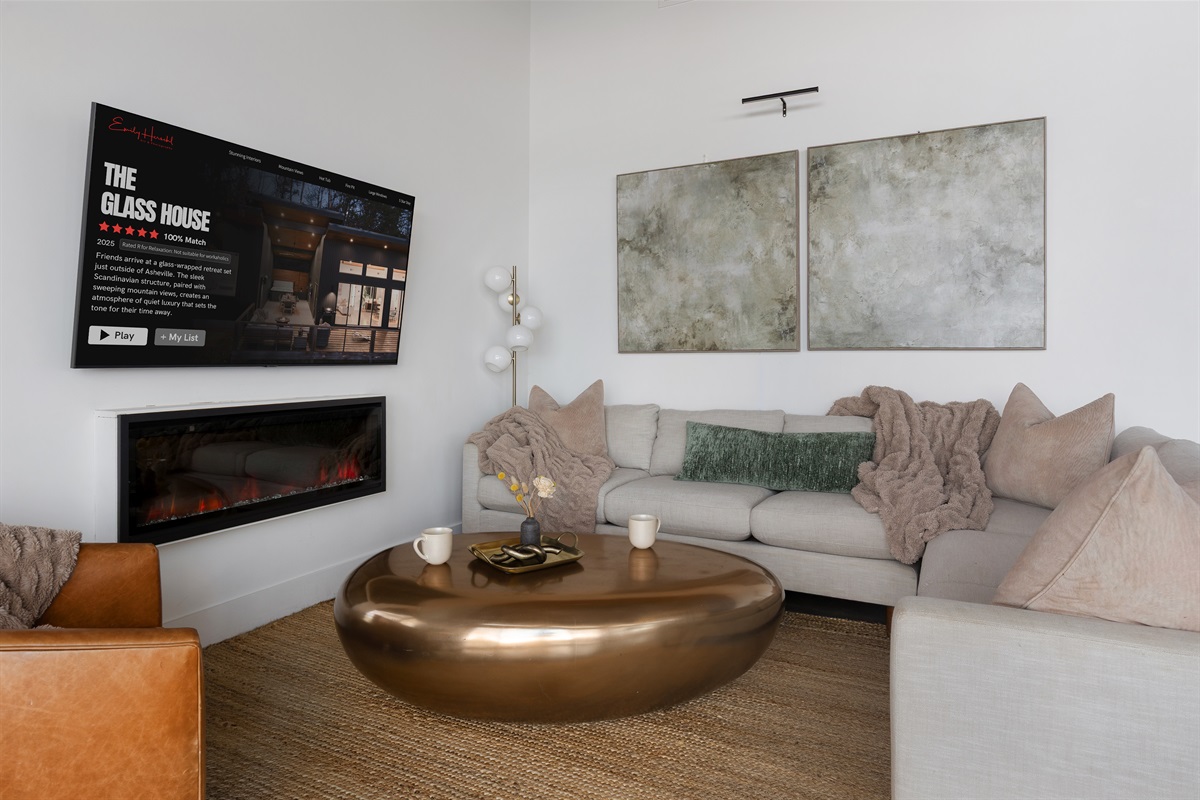 {Living Room} A serene, neutral lounge with a warm fire and your own Netflix moment—designed for effortless relaxation.