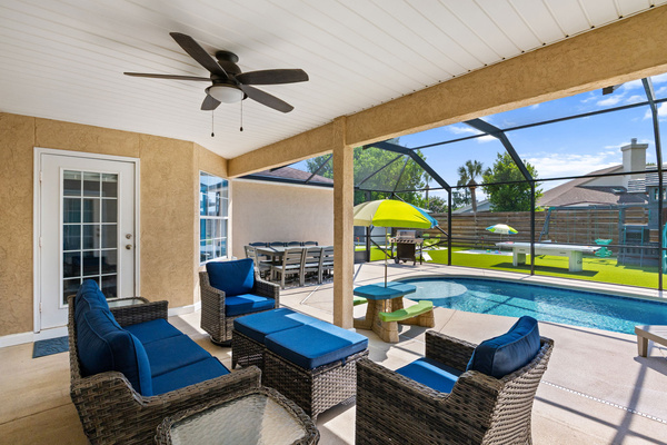 Relax under the shaded lanai! Features a 3-seat couch, 2 swivel chairs with ottomans, and a ceiling fan. The perfect spot to watch the pool and the kids hanging out at their own umbrella picnic table.