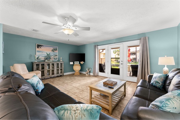 Large, spacious living area with new furniture and access to our patio