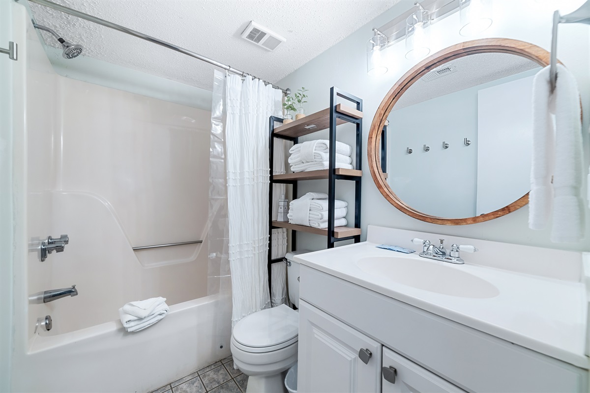 Freshly updated bathroom featuring a shower/tub combination, ample vanity space, and modern fixtures.