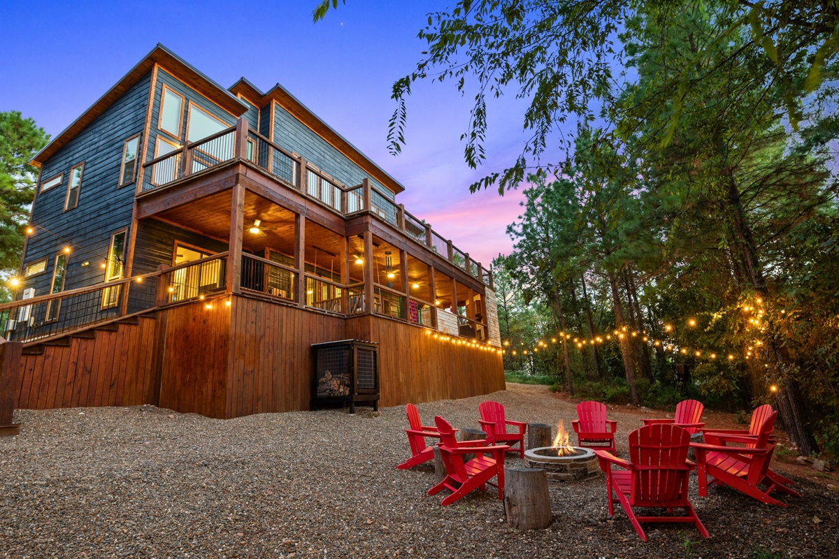 The cabin’s exterior shines at dusk, blending modern comforts with rustic charm for a welcoming retreat.