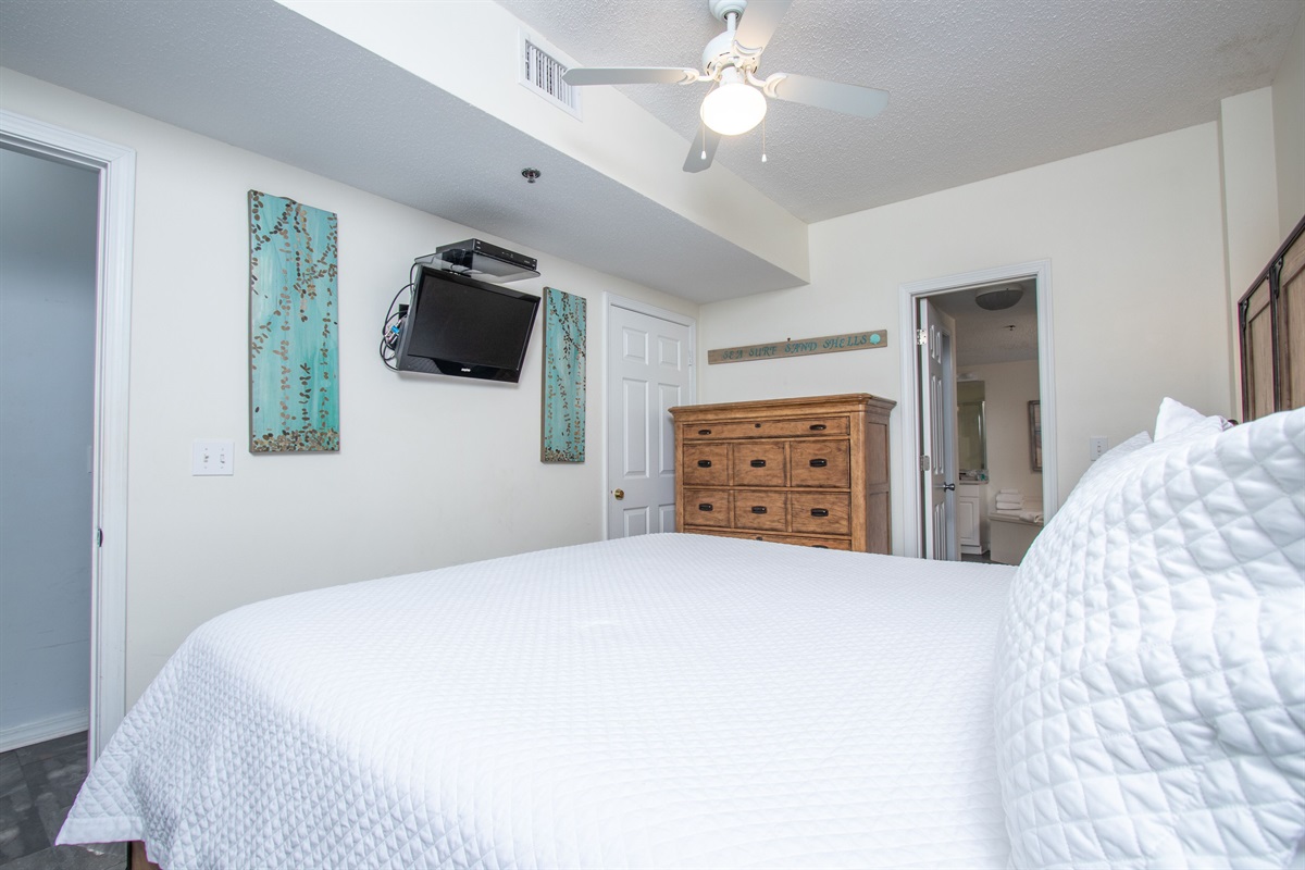 Primary Bedroom with King bed, ceiling fan and TV