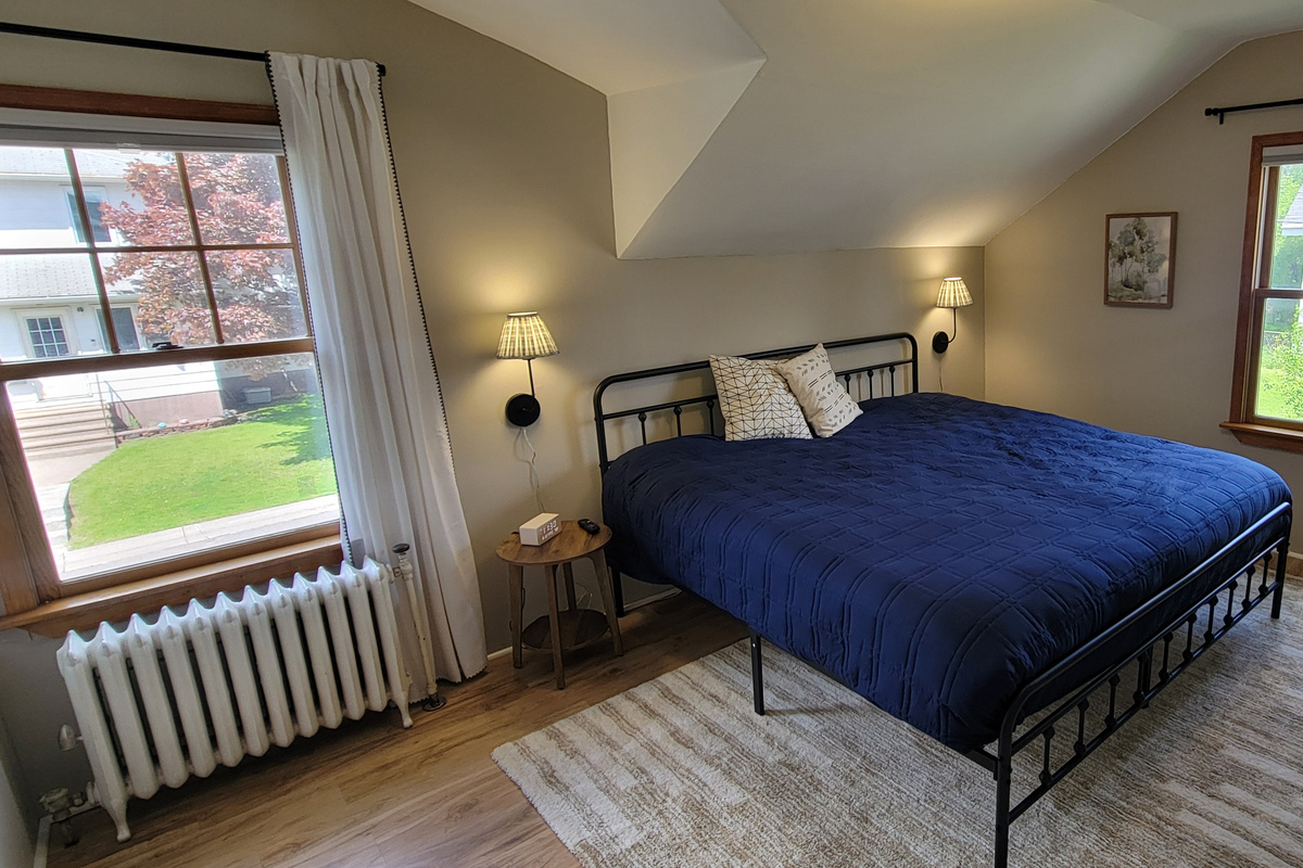 Main bedroom with a comfortable king bed and cozy setup for a restful night.