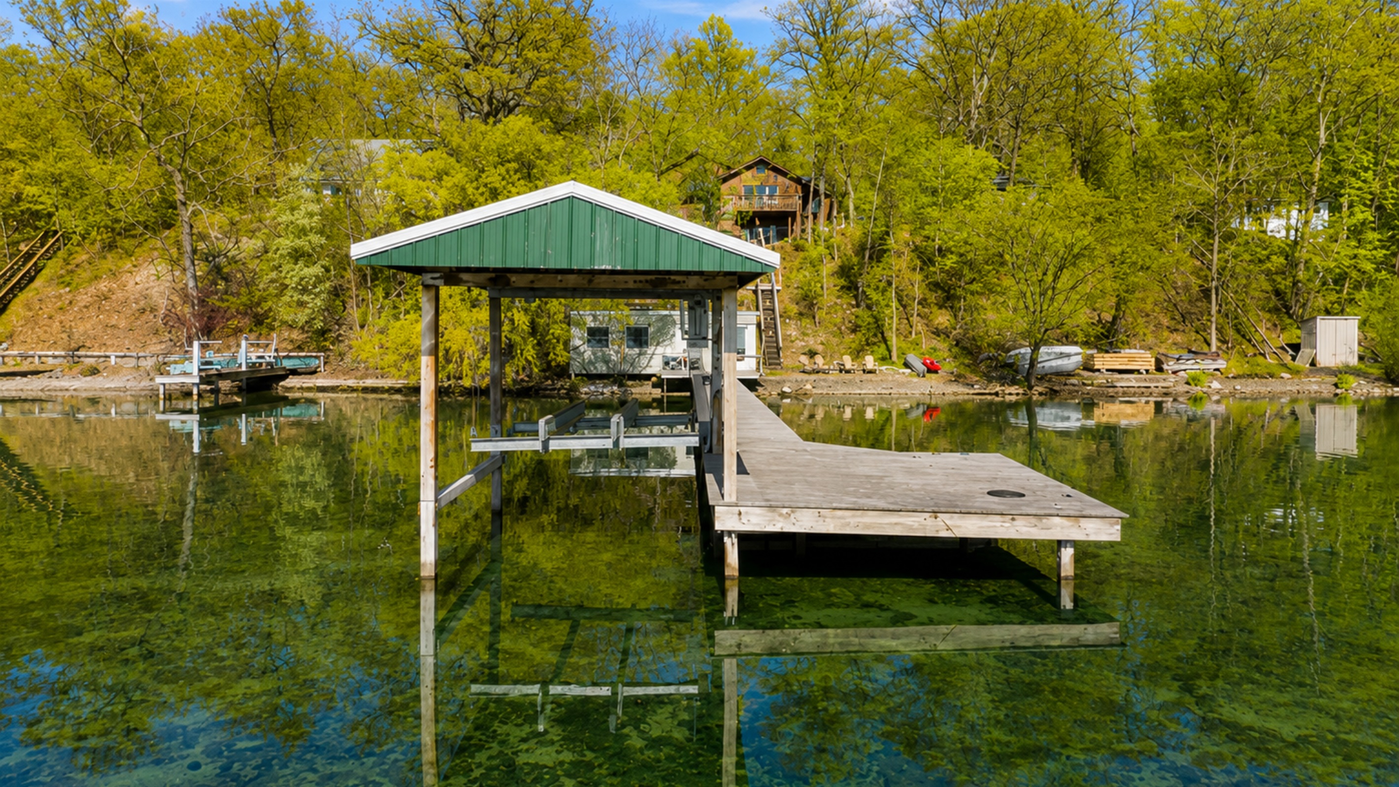 Lakefront / Boathouse / Dock (requires three flights of stairs to access) - Experience serene lakeside living with our private dock and boathouse, perfect for relaxation and water activities. Ideal for those seeking a peaceful waterfront getaway. 