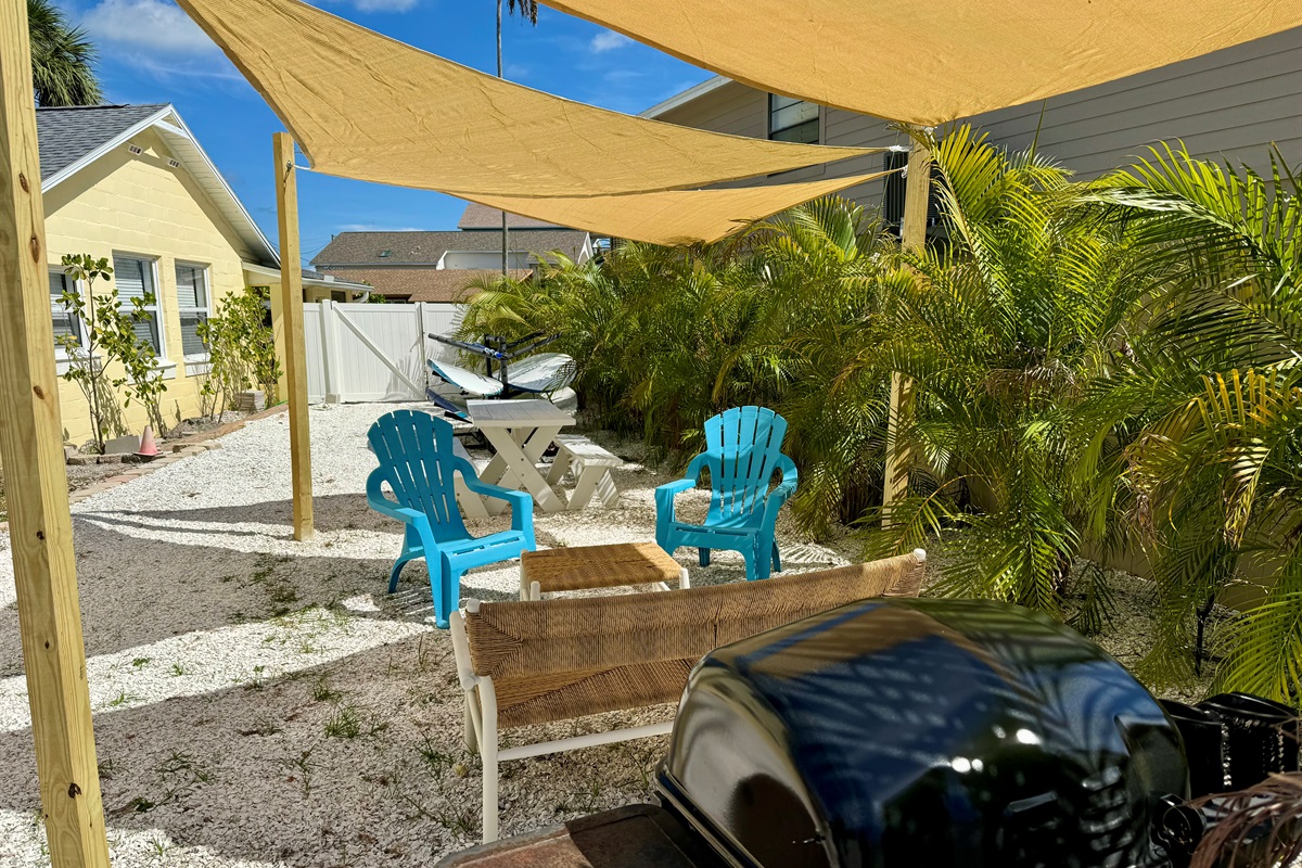 Outdoor lounge with seating and gas grill