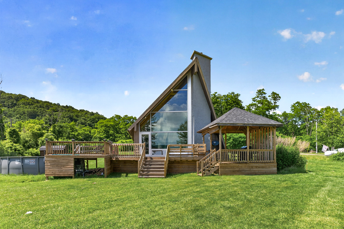 Home with wraparound deck and large windows