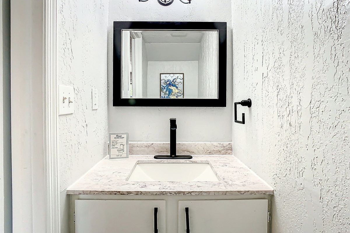 Modern kitchen featuring granite countertops, stainless steel appliances, and warm wood cabinetry for gourmet cooking.