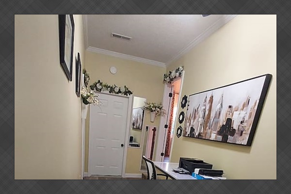 This private, lockable office doubles as a bedroom. The lightweight, wheeled desk easily rolls in front of the laundry room door to clear space for a full-size floor mattress on the rug. Linens, pillows, and a mattress cover are provided.