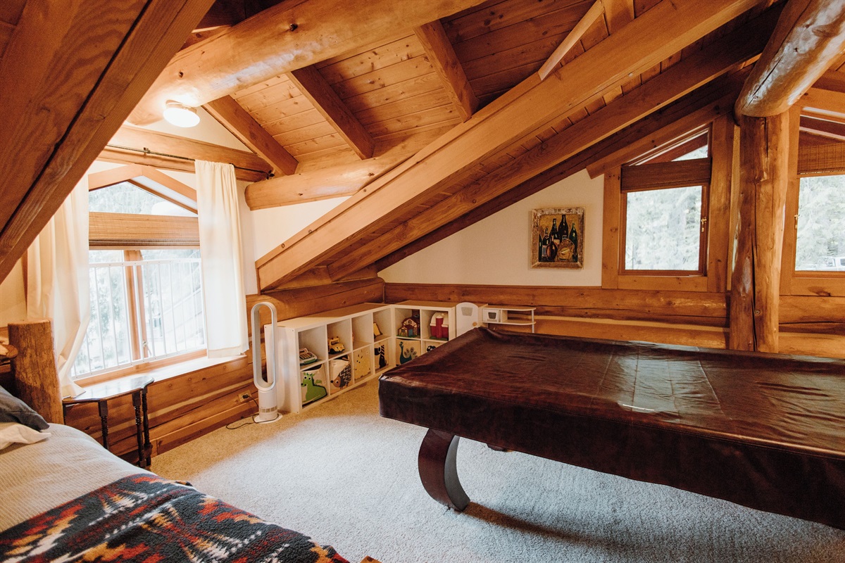 Toy area, pool table and a second king bed on the third floor.