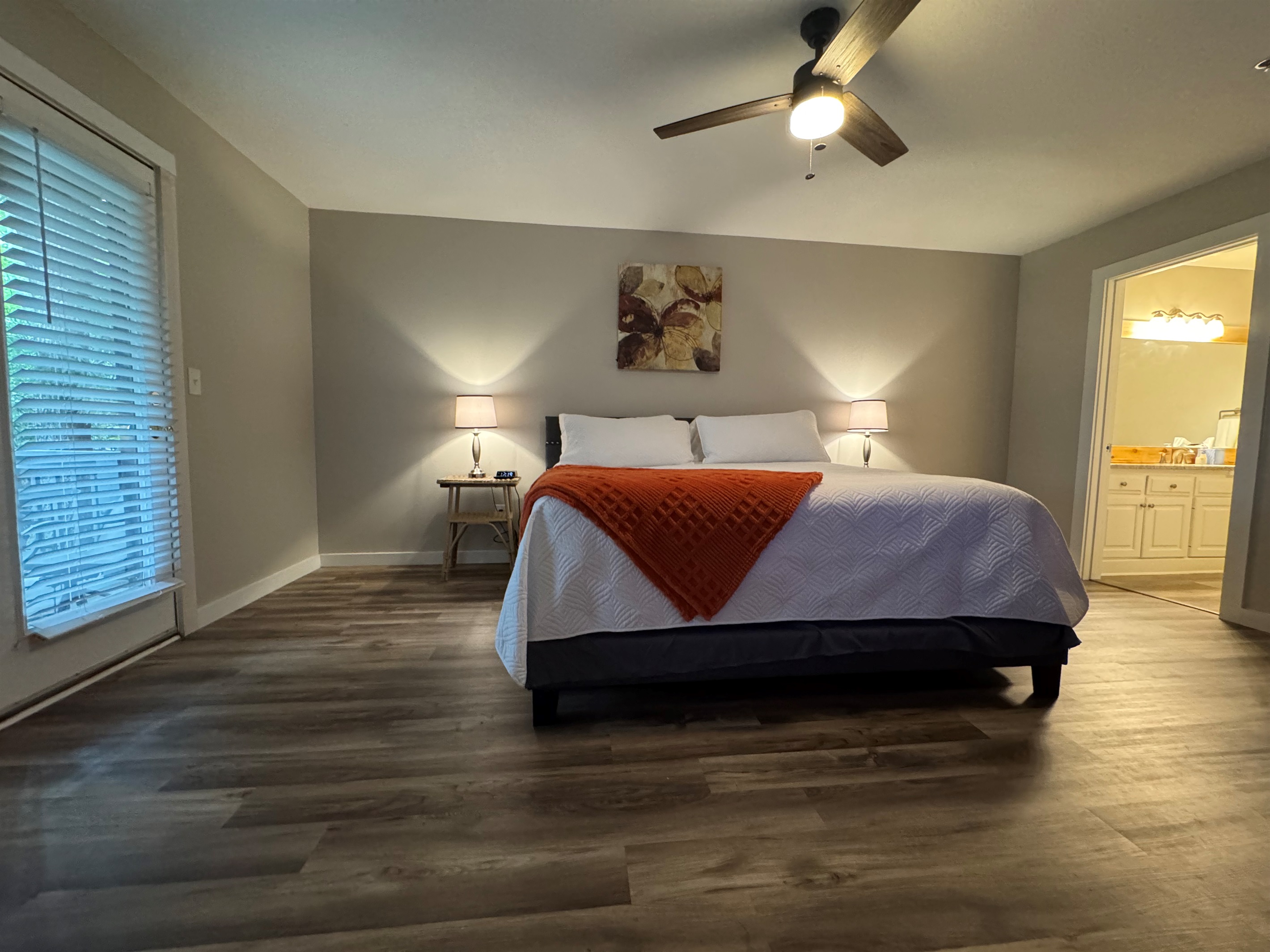 Enjoy the spacious bedroom with king bed, ceiling fan, and ensuite bath—plus direct access to the patio.