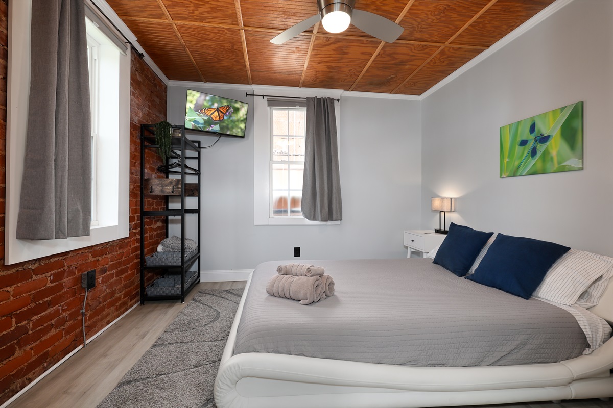 Bedroom with queen bed and Roku TV