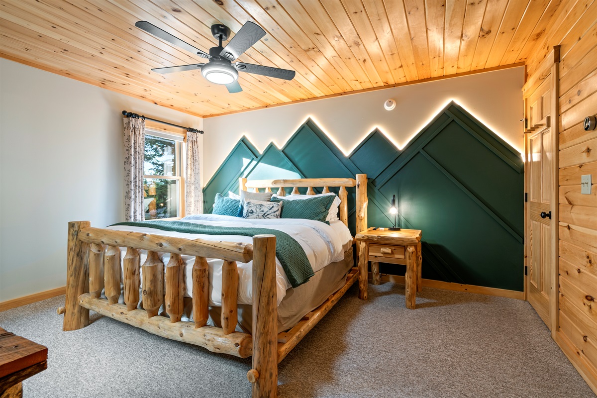 The first bedroom boasts a spacious king bed for a restful night’s sleep.