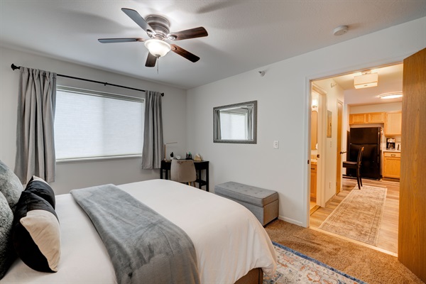 Cozy bedroom with black out shades and ceiling fan - perfect for a restful stay in the mountains.