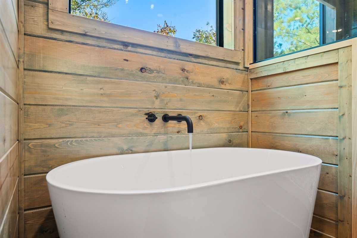 Warm wood tones and a minimalist design make this bathroom feel like a true retreat after a day exploring Broken Bow.