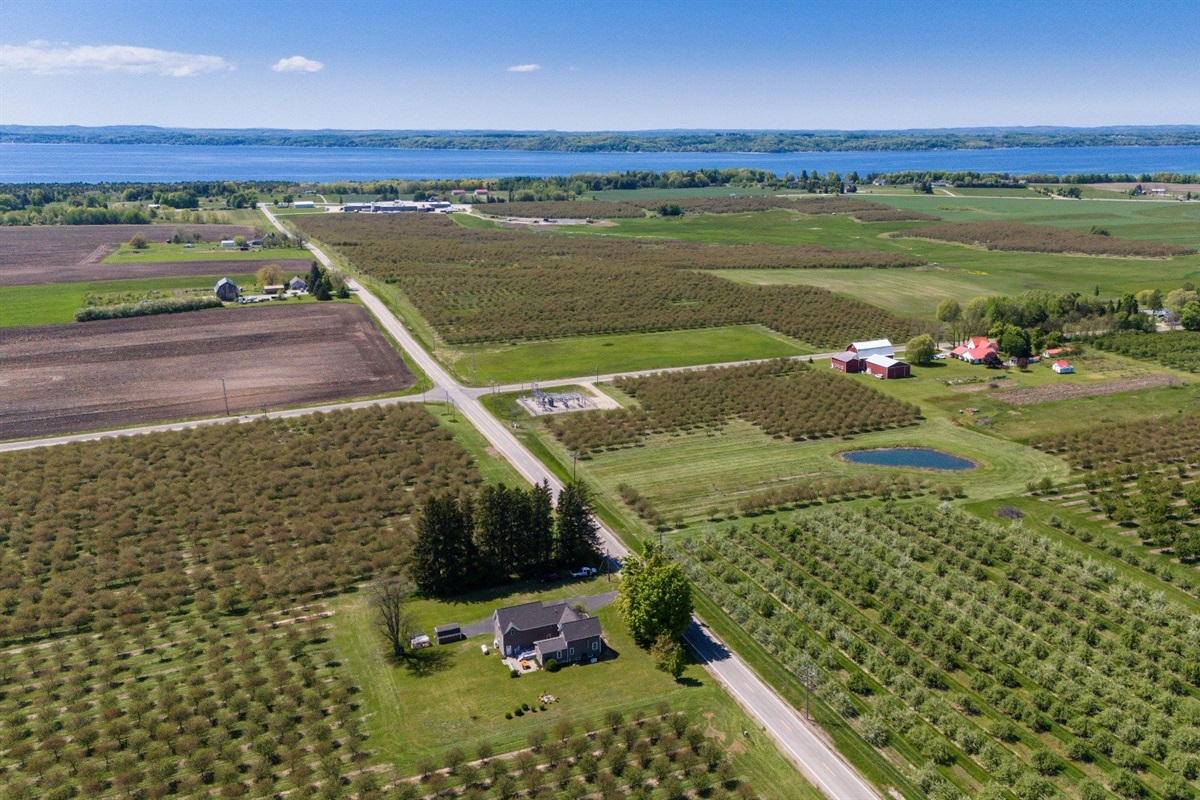 Surrounded by orchards with distant lake views.