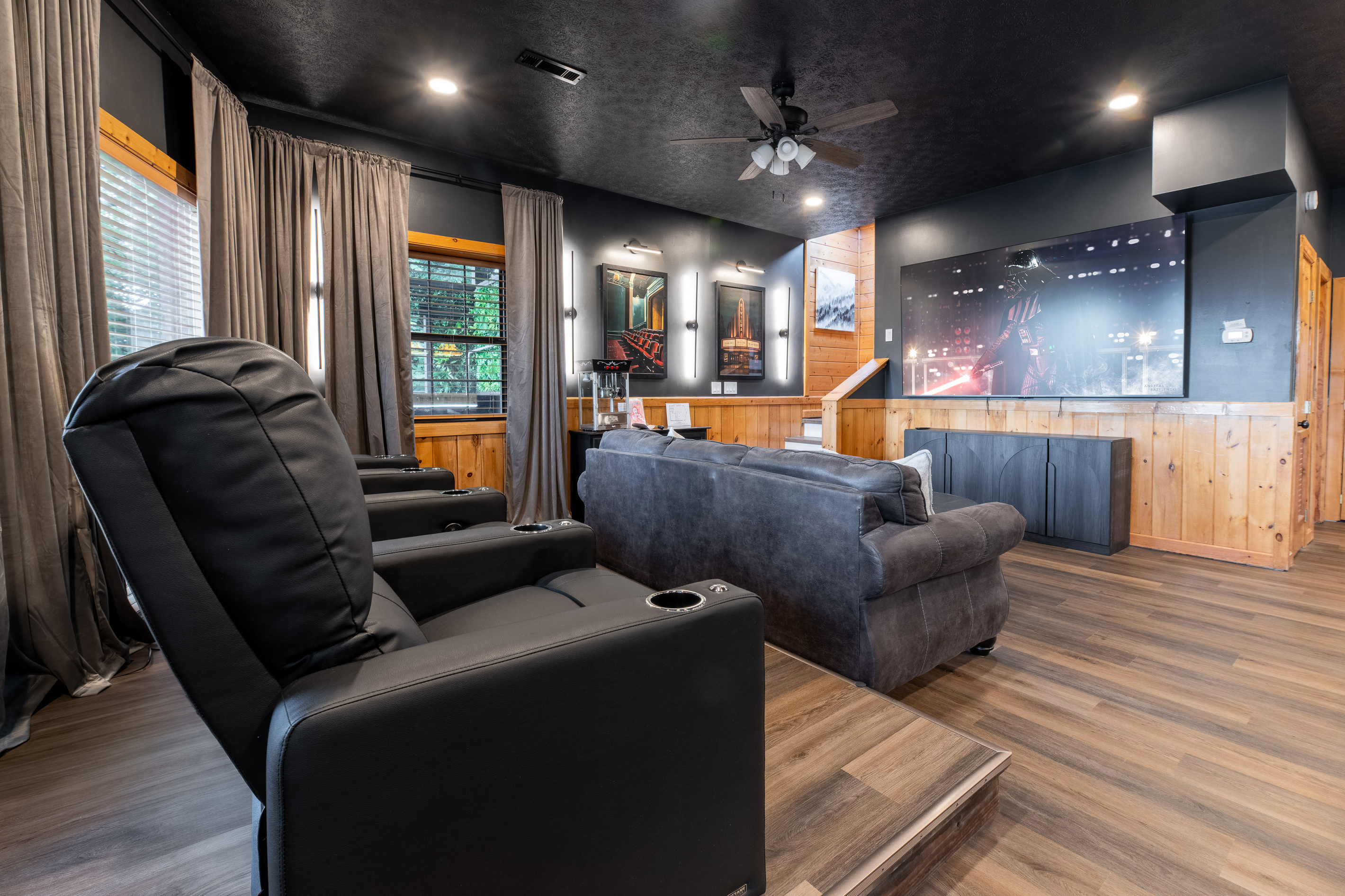 Theater room with large 98 inch TV with comfortable seating on reclining theater seats