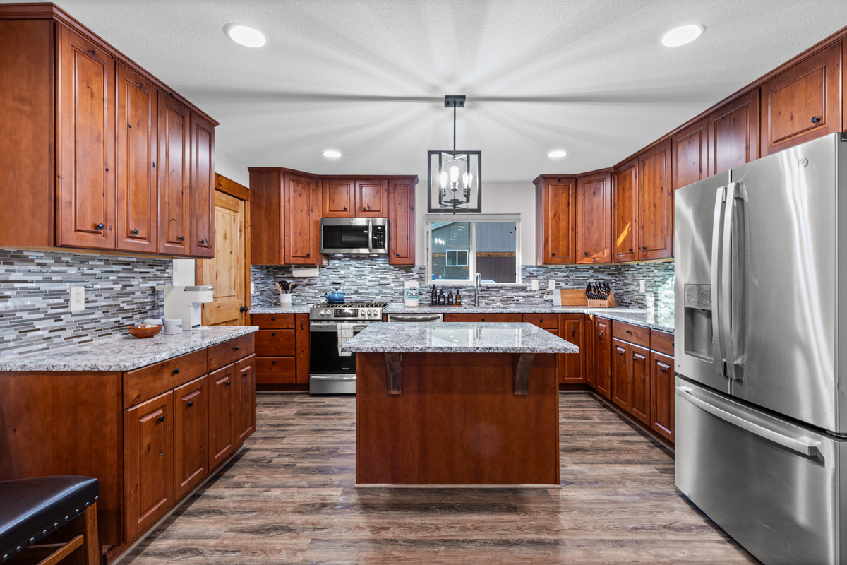 Kitchen with oven, island and refrigerator