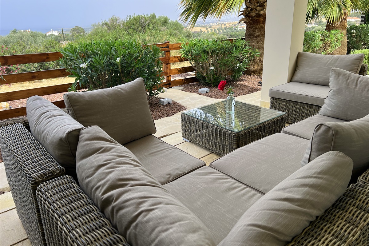 Large sectional sofa on the covered patio inviting guests to relax and enjoy the garden and the views.