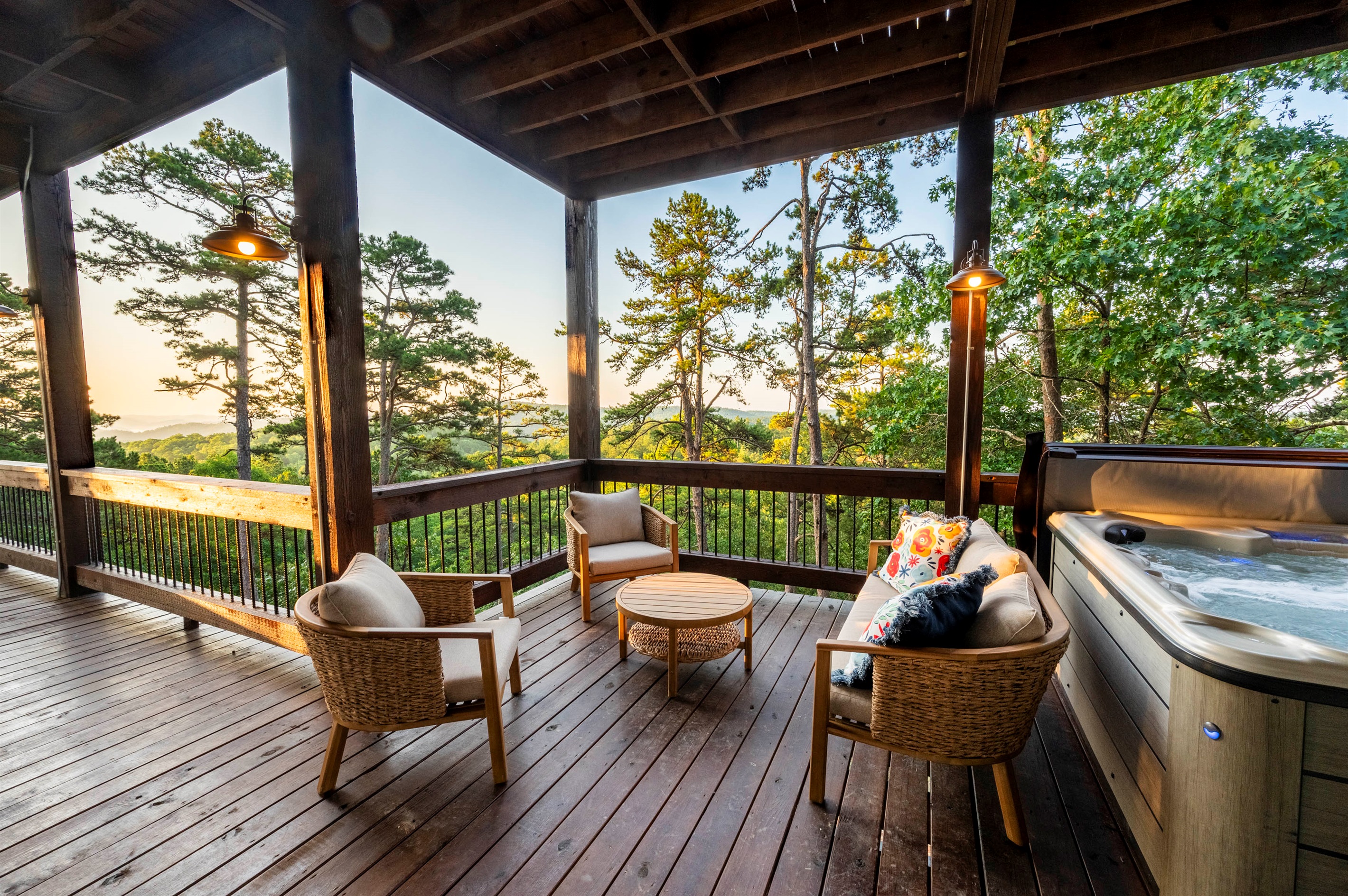 Spacious deck retreat featuring hot tub, lounge seating, and sunset views