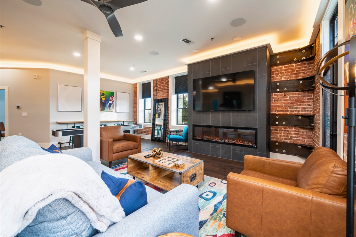 [Fireplace] Cozy Living Room with a Gas Fireplace and an Abundance of Lighting