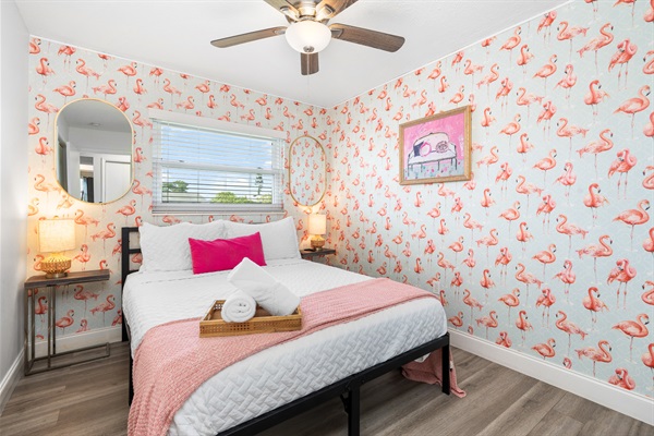 Step into the Pink Room—equipped with a queen bed. This isn't just a room — it’s a vibe 💕 Flamingos on the wall, cozy on the bed, and pure Florida charm. 📸 You’re going to want to take all the selfies here.