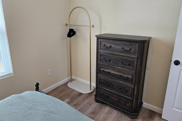 Queen bedroom dresser and clothes rack.