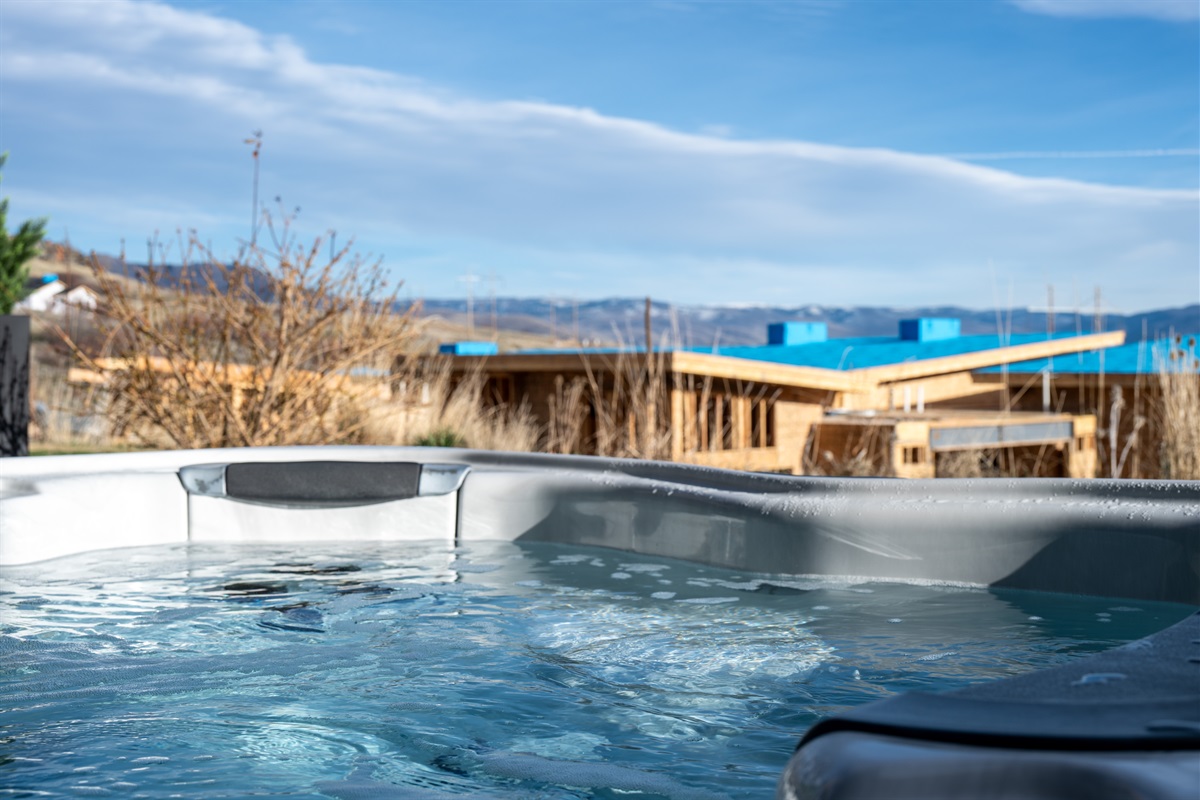 Relaxing hot tub with expansive mountain and lake views