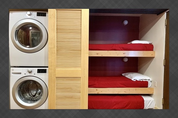 Stack-washer/dryer next to bedroom. 