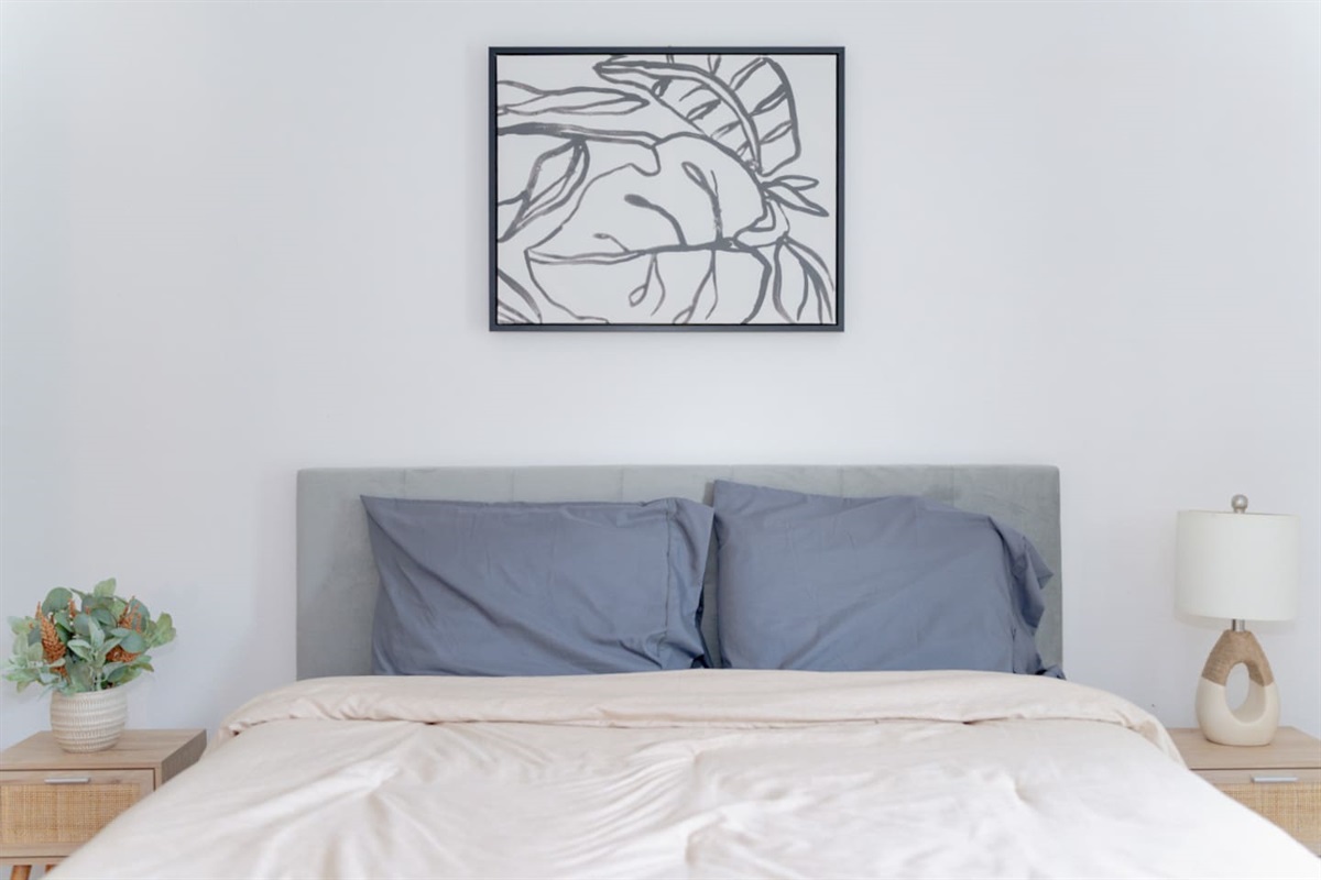 Guest bedroom with queen bed and minimalist design.