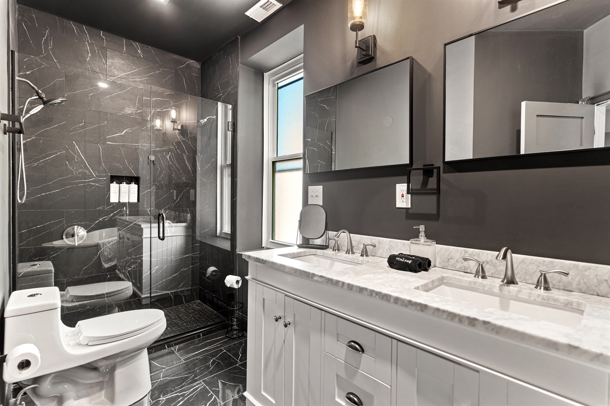 Refresh and recharge in the spa-like primary bath with a double vanity and oversized walk-in shower.