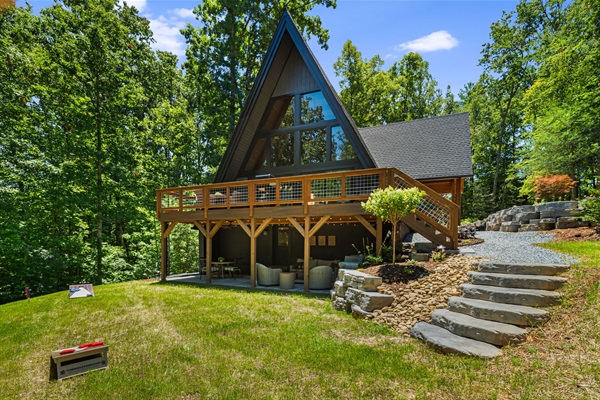 Relax on the spacious the deck overlooking the trees and backyard, and cozy evenings on the covered patio with string lights and super comfortable furniture that invites you to unwind and recharge. 