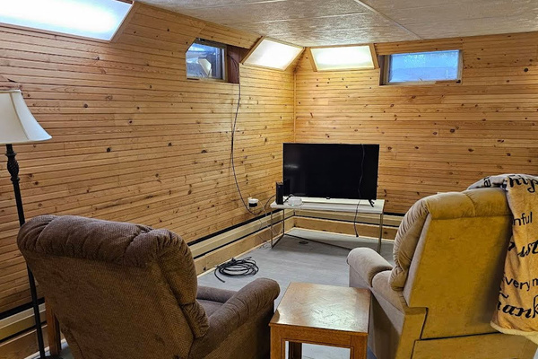 Sitting area with Roku smart TV next to basement bedroom