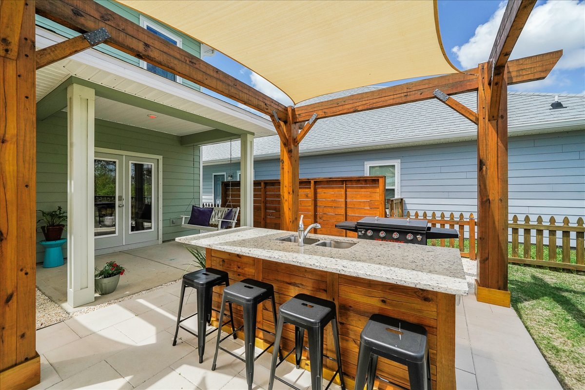 Outdoor bar with sink and 4 bar stools
