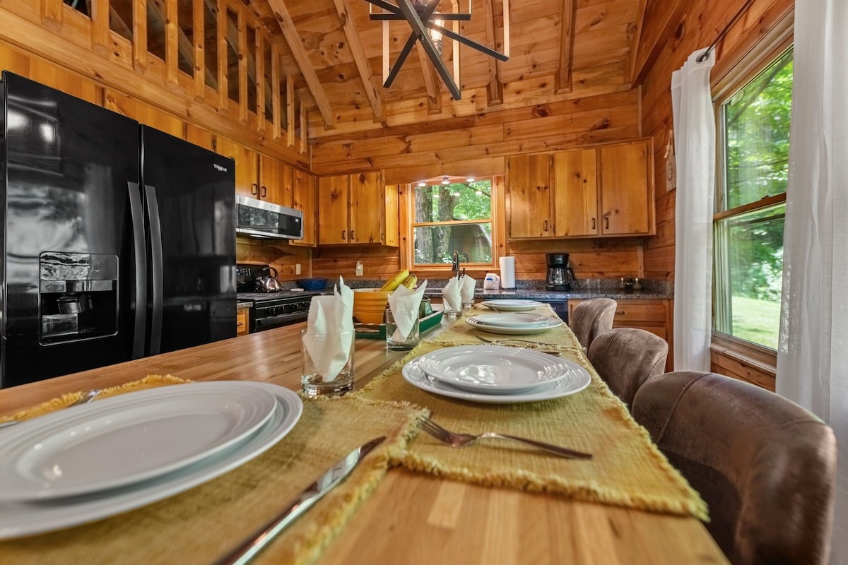 Dining table/island is in the kitchen and open to living room for everyone to congregate and talk with cooking, eating, etc.