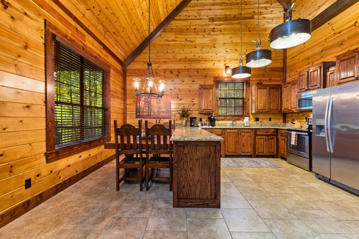 Rustic dining space with large windows to enjoy wooded views as you eat.