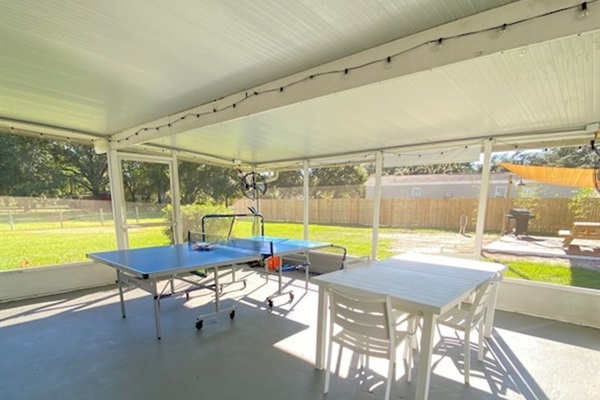 spacious screened porch outside seating with fans