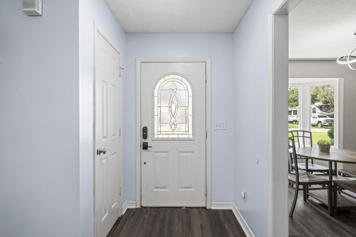 Step inside to a light, airy entryway with rich wood-look flooring and a keyless smart lock for easy check-in.