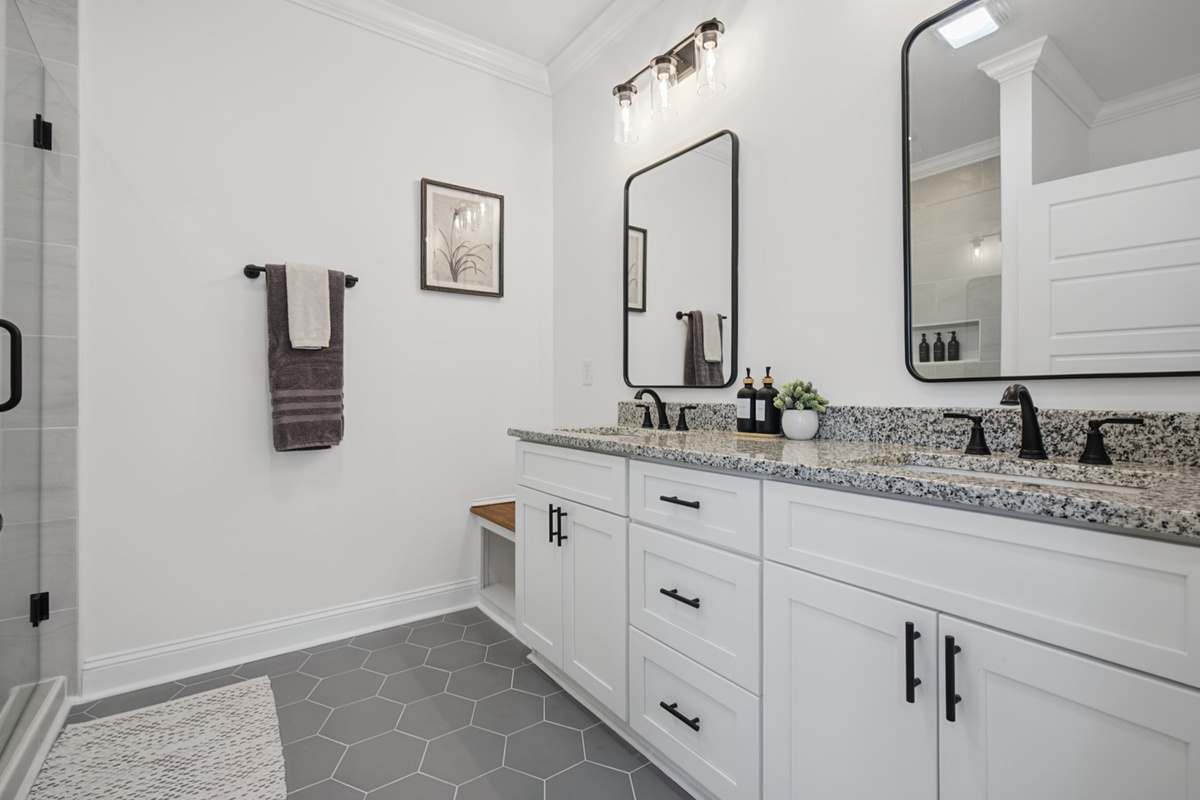 Primary ensuite with a double granite vanity and walk-in shower