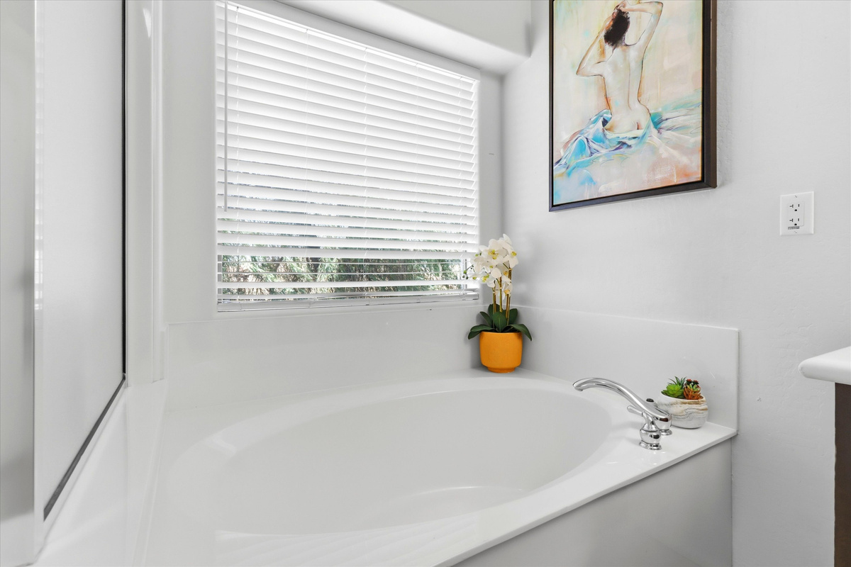 Soaking tub with window light and a calm spot to relax after the day.
