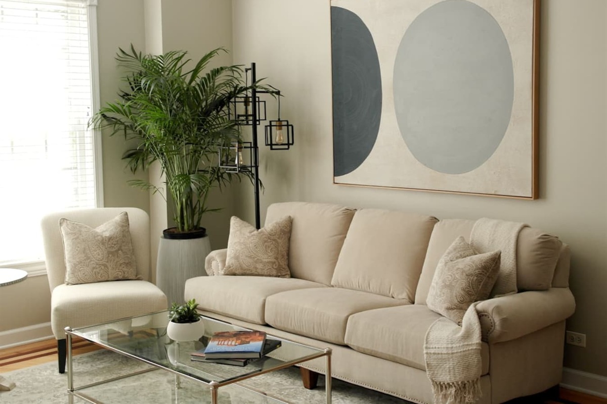 Spacious sun-filled living room with comfortable seating, smart tv, and modern decor — perfect for relaxing after exploring Chicago.