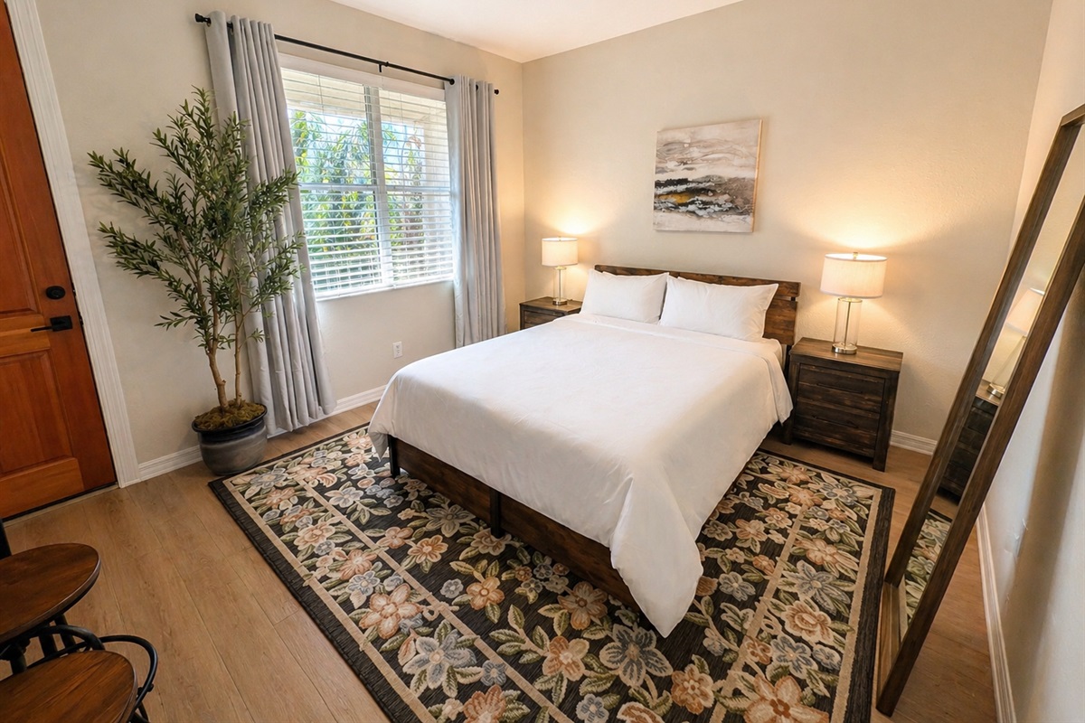 Cozy and well-appointed bedroom with a comfortable bed, soft lighting, and stylish décor. Enjoy natural light from the window and a calm, relaxing atmosphere perfect for a restful night’s sleep.