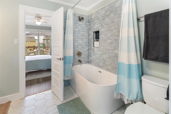 Shower over large tub for a relaxing post beach bath.