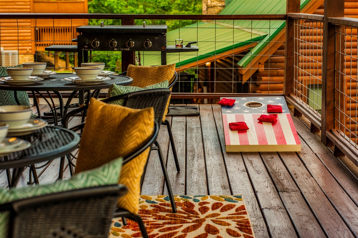 Our upper level deck offers dining, hot tub, a Blackstone grill, and cornhole.