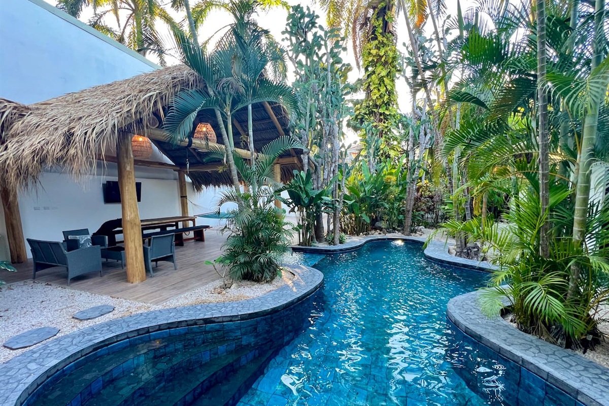 Laguna Azul at dusk with the sunlight filtering down through the palm branches.  